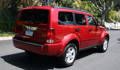 A three-quarter rear view of a red 2007 Dodge Nitro SLT